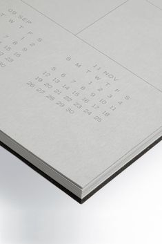 an open book with numbers and times on the front cover, sitting on a white surface