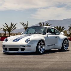 a white sports car parked in a parking lot