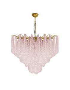 a pink chandelier hanging from a gold ceiling fixture with crystal drops on it