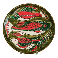 a decorative plate with fish painted on it