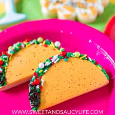 two pieces of cake sitting on top of a pink plate with sprinkles