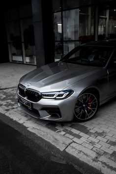 a silver car parked in front of a building