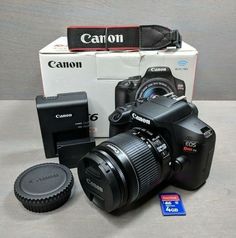 a canon camera sitting on top of a table next to a box