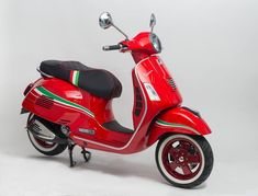 a red scooter is parked on a white background