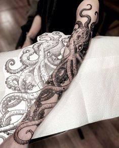 an octopus tattoo is on the arm of a man in black and white inks