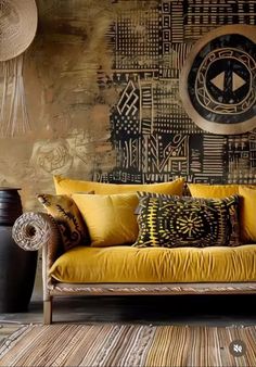 a couch with yellow pillows in front of a large clock on the wall behind it