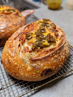 two breads sitting on top of a cooling rack