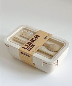 an open lunch box with two forks in it