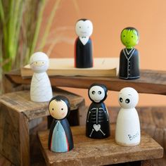 small figurines sitting on top of a wooden table