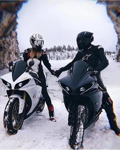 two people on motor bikes in the snow