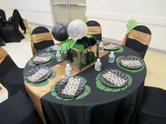 a table set up for a party with black and white decorations