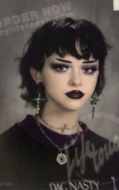 a woman with black lipstick and piercings on her face