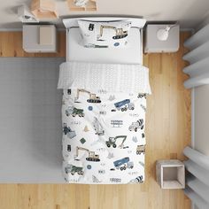 an overhead view of a bed with construction themed sheets and pillowcases on it