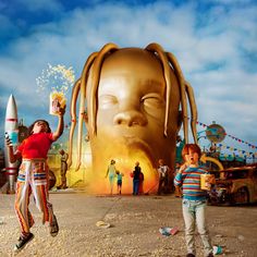 two children standing in front of a giant head