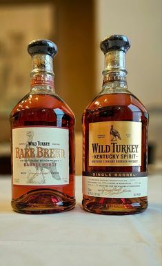 two bottles of wild turkey whiskey on a table