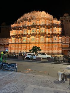 an ornate building lit up at night in india