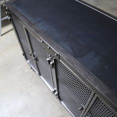 a black metal cabinet sitting on top of a floor