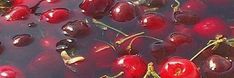 cherries floating in water with green stems and red berries on the surface, top view