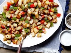 a white plate topped with potatoes and peppers