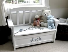 two teddy bears sitting on a toy bench in front of a window with the name jack written on it