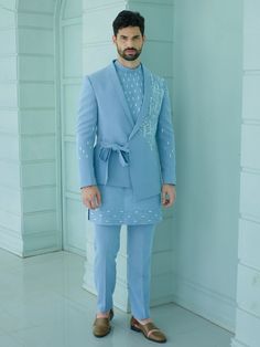 Blue Colour Handcrafted Designer Indowestern for groom or family & friends with elegant kurta inside made from the finest fabric will make you feel like a king on the happiest & most important day of your life.you can customize it according to your measurement as the fitting make it more beautiful to wear.Its beautifully hand embroidered and zari work on blazer & kurta,indowestern for men,indo western dress for men COST INCLUDED SHERWANI ,TROUSER & KURTA AS IN THE PICTURE New Dress Designs For Men, Indowestern Groom Outfit, Fitted Blue Kurta For Groom, Blue Sherwani For Wedding, Fitted Blue Sherwani For Groom, Blue Fitted Sherwani For Groom, Fitted Blue Bandhgala For Groom, Fitted Nehru Jacket With Traditional Drape For Groom, Blue Semi-formal Suits For Eid