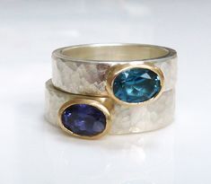 A solid 925  recycled sterling silver  ring, hammered texture on the outside of the band, smooth on the inside. Gemstone rings set with oval iolite or london blue topaz in 9ct yellow gold.  The band is 5mm wide and 2mm thick. I have an iolite ring in stock,size is just over 6.5 (US), M1/2 (UK)  or 53.5 ( European). the oval iolite, almost sapphire blue  with a delicate hint of grey, measures 7mm x 5mm and is set in 9ct yellow gold for a contrast. It can also be set with any stone of your choice Iolite Ring, Expensive Stones, Blue Gemstone Ring, Bezel Jewelry, Creative Jewelry Photography, Blue Gemstone Rings, London Blue Topaz Ring, Cabochon Ring, Silver Wedding Rings