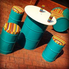 colorful chairs and tables made out of plastic barrels