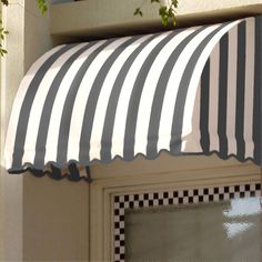 a black and white striped awning over a door