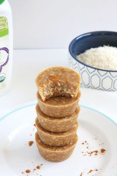 a stack of pancakes sitting on top of a white plate next to a bottle of milk