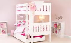 a white bunk bed sitting in a bedroom