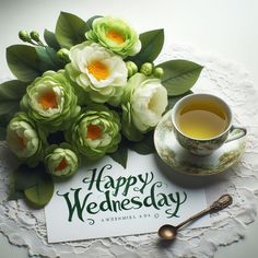 there is a cup of tea and some flowers on the doily next to it