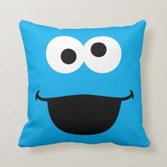 a blue pillow with eyes and a mustache