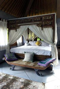 a bed sitting in the middle of a room next to a rug on the floor