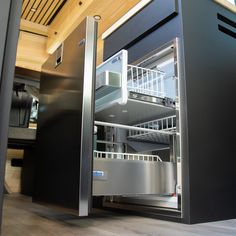 an open refrigerator in a kitchen with stainless steel doors