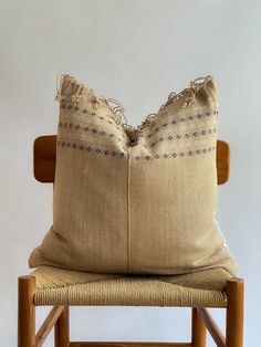 a pillow sitting on top of a wooden chair