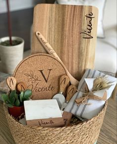 a wooden cutting board sitting inside of a basket filled with soaps and other items