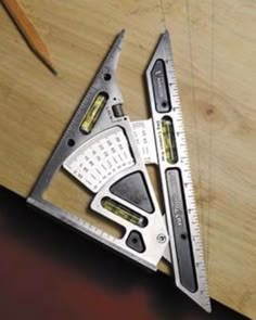 a wooden table topped with two rulers and a pair of scissors