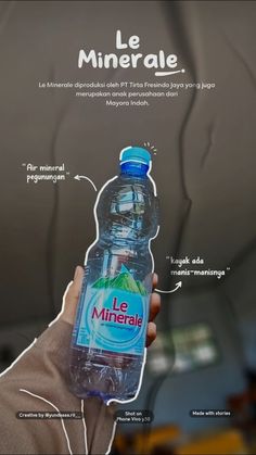 a person holding up a bottle of water with instructions on how to use the label