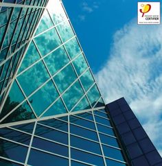 a tall building with many windows and clouds in the background