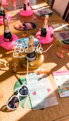 the table is covered with pink flamingos and personalized items for bachelor party guests