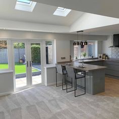 an open kitchen and living room with sliding glass doors leading to the back patio area