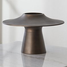 a metal object sitting on top of a white counter