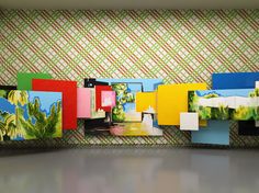 an art installation with colorful paintings on the wall