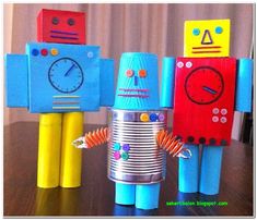 three paper toy robots standing next to each other on a table