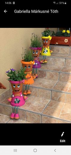 there are many potted plants on the steps in front of each other, with faces painted on them