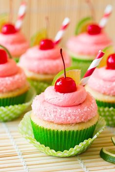 cupcakes with pink frosting and a cherry on top