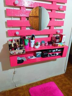 there is a pink shelf with makeup on it