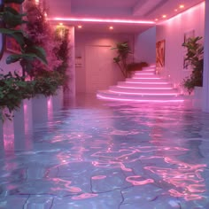 an indoor swimming pool with pink lights and steps leading up to the water's edge