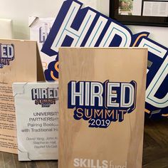 there are several cardboard signs on the floor next to each other, including one that says hired summit