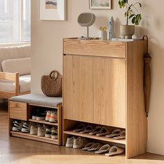 a wooden cabinet with shoes on it in a living room